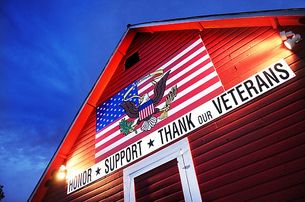 Dick Sauerbier's barn is lit up against the evening sky on Tuesday in Kalispell. In the summer and fall of 2009 Sauerbier painted the barn and put the sign up. The barn can be seen from W. Reserve Drive near Cherry Lynn.