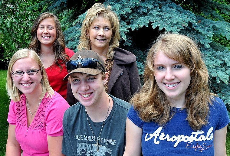 From left, Kayla Kjos, Amy Snipstead, Mike Druesdow, Cheri Nelson and Ashley Sonju of Faith Lutheran Church helped rescue a man from a smoking car near St. Regis on Wednesday.