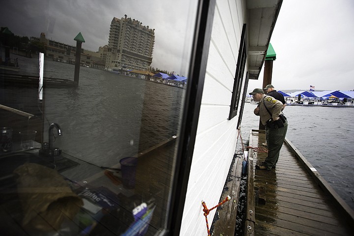 &lt;p&gt;SHAWN GUST/Press Sgt. Ryna Higgins, with the Kootenai County Sheriff's Office Marine Division, looks into the window of a boat that was reported to be sinking Thursday at the Third Street marina on Lake Coeur d'Alene as deputy Tim Leeder inspects the area around the bow. The owner of the vessel was contacted about the tilt, or list as it's know in nautical terms, of the house boat.&lt;/p&gt;