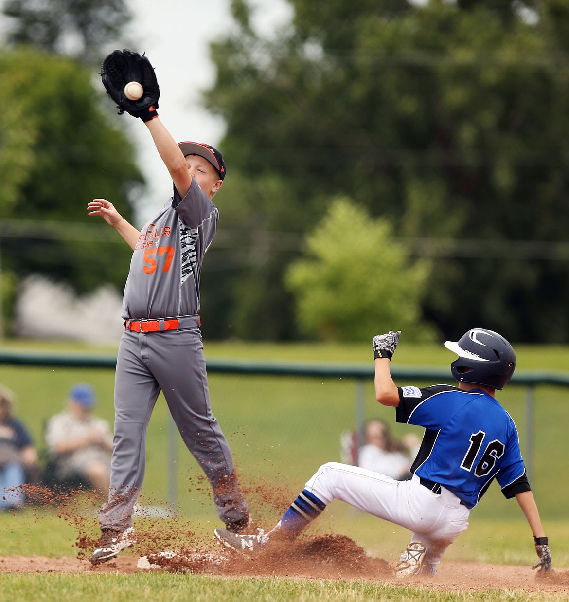 &lt;p&gt;LOREN BENOIT/Press Coeur d'Alene's Quinn Conses, right, slides safely into third base ahead of the catch of Post Falls' Devin Myers on Saturday at Canfield Middle School.&lt;/p&gt;