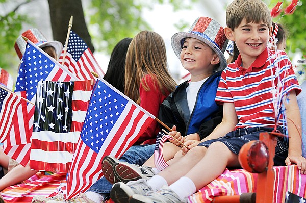 Bennett Dykstra, 7, right, and his brother Ethan Dykstra, 4, both of Kalispell, take in the view as they wait for the beginning of the parade on Saturday in Kalispell.
