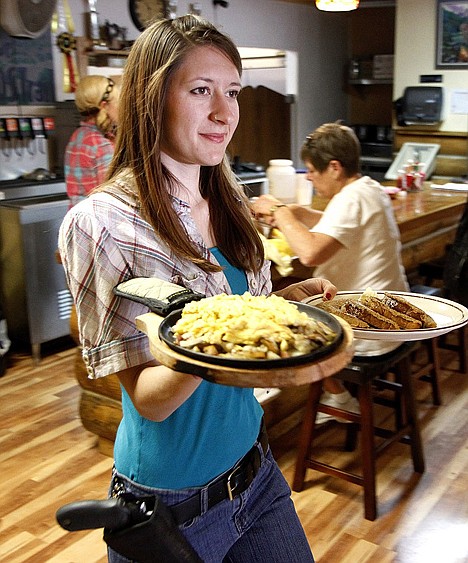 &lt;p&gt;Jessie Spaulding a waitress at the Shooters Grill in Rifle, Colo., brings food to a table June 23.&lt;/p&gt;