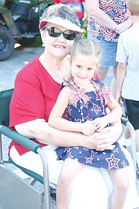 &lt;p&gt;Claire Fantozzi, in her festive dress, sits with grandmother, Marcia, during Troy's Fourth of July parade.&lt;/p&gt;