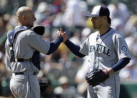 &lt;p&gt;Seattle's Brandon League, right, celebrates a 2-1 win over the Oakland Athletics on Monday with catcher Josh Bard in Oakland, Calif.&lt;/p&gt;