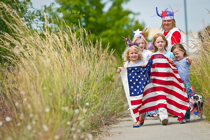 &lt;p&gt;Joely Gardiner, left, Emma Marks and Ellie Deaton lead a patriotic parade as they march along a overgrown section of sidewalk in Coeur d'Alene, in this 2012 file photo.&lt;/p&gt;