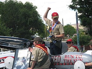 Boy Scout Troop No. 44 member Michael Allen, raises his arm and smiles after the Smokiam Days parade in Soap Lake Saturday. He is holding the Parade Director's Choice Award.