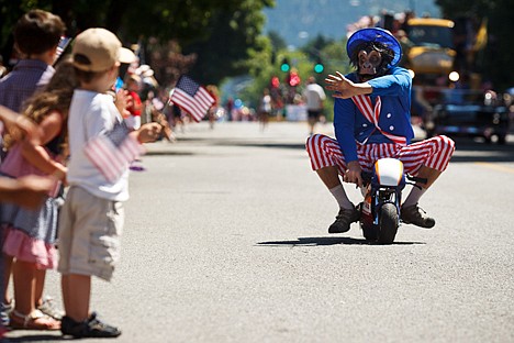 &lt;p&gt;Scott Shawver, owner of Body by Scotty, waves to parade-goers from his mini bike Monday during the American Hero's Parade in Coeur d'Alene. Thousands lined Sherman Avenue to witness the annual event in celebration of Independence Day.&lt;/p&gt;