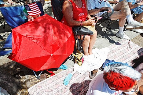 &lt;p&gt;Alexander Carr, 6, watches the parade from behind an umbrella as his brother Aaron, 12, right, celebrates Independence Day with red, white and blue hair spray.&lt;/p&gt;