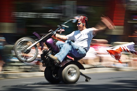 &lt;p&gt;Mike Sims, a member of the Shriners' Um Al Jamal three-wheelers group, rides a wheelie passed the crowd during the American Hero's Parade.&lt;/p&gt;