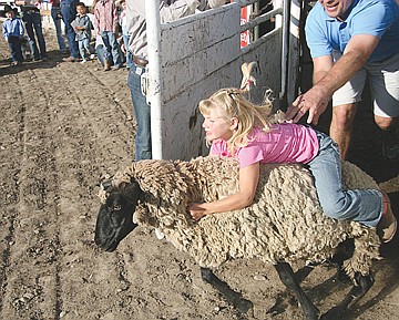 &lt;p&gt;Kylee Seifert of Polson settles in for a rough ride aboard a renegade sheep in Saturday's mutton bustin' event at last weekend's Mission Mountain Rodeo.&lt;/p&gt;