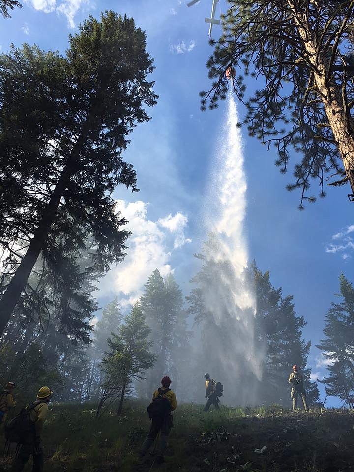 <p>A helicopter was called in to drop buckets of water onto the wildlife located near Thompson Creek, west of Superior on Wednesday, June 29.</p>