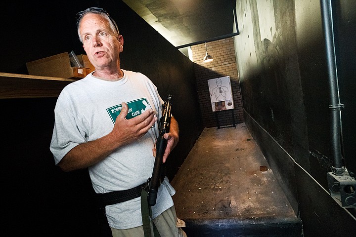 <p>SHAWN GUST/Press Eric Johnson, owner of the Shoot House in Coeur d'Alene, describes the various weapon modifications that are used in the shop's Zombie Fight Club.</p>