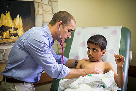 &lt;p&gt;Marty Williams, family nurse practitioner with Coeur d'Alene Pediatrics, examines Hasibullah, of Afghanistan.&lt;/p&gt;