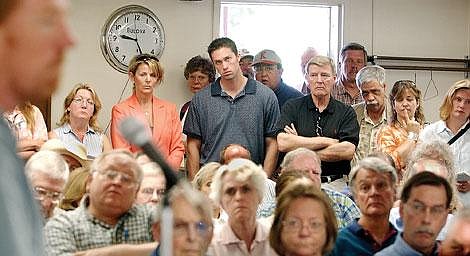 Flathead residents listen to planning board president Don Hines speak at Tuesday morning's discussion with Flathead County Commissioners on the future of Flathead Valley's growth-policy amendments. Chris Jordan/Daily Inter Lake