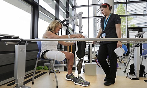 &lt;p&gt;Boston Marathon bombing survivor Roseann Sdoia, of Boston, talks with physical therapist Dara Casparian as she prepares to fit her prosthetic leg at the Spaulding Rehabilitation Hospital, June 20, in Boston.&lt;/p&gt;