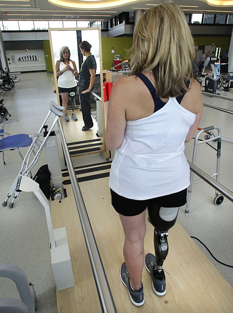 &lt;p&gt;Boston Marathon bombing survivor Roseann Sdoia, of Boston, looks at herself in a mirror as she stands while talking with her physical therapist Dara Casparian at the Spaulding Rehabilitation Hospital, June 20, 2013, in Boston.&lt;/p&gt;