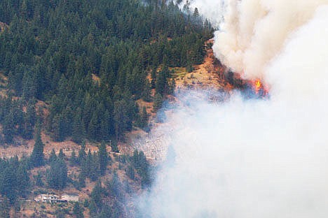 &lt;p&gt;Flames and smoke approach a home on Cape Horn in Bayview on Sunday.&lt;/p&gt;