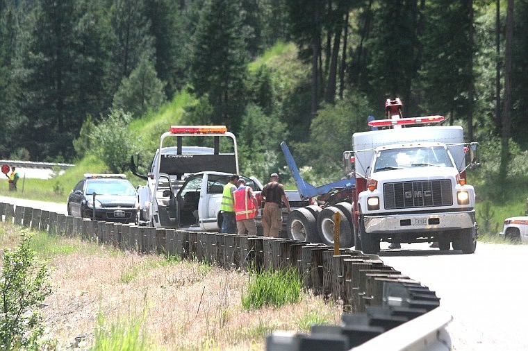 &lt;p&gt;Towing rigs prepare to haul the wrecked truck and trailer from the scene of the accident Friday afternoon on hwy 135, mile marker 5.&lt;/p&gt;