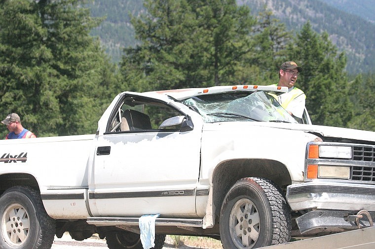 &lt;p&gt;A Schobert's Towing employee directs the steering of the damaged truck Friday as they prepare to haul it from the scene of the rollover accident.&lt;/p&gt;