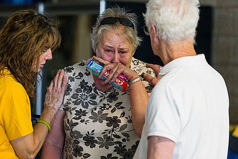 &lt;p&gt;An emotional Jeannie Wilkins is comforted by her husband Byron and Carla Floyd, a chaplain with Southern Baptist Disaster Relief, after the Wilkins, a Bayview couple, arrived at Timberlake High School in Spirit Lake Monday in search of aid from the American Red Cross.&lt;/p&gt;