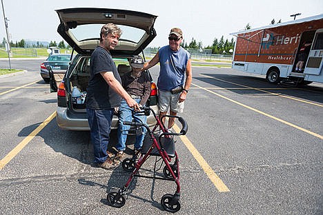 &lt;p&gt;Walter Doerflinger rests in the back of a vehicle as his son John, left, and Fred Peterson wait for medical for the elderly Bayview resident in the parking lot of Timberlake High.&lt;/p&gt;