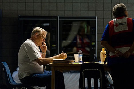 &lt;p&gt;During his shift at Timberlake High School, Red Cross volunteer Bill Scarbrough speaks on the phone with an organization offering services to veterans who may be displaced by the Cape Horn fire.&lt;/p&gt;