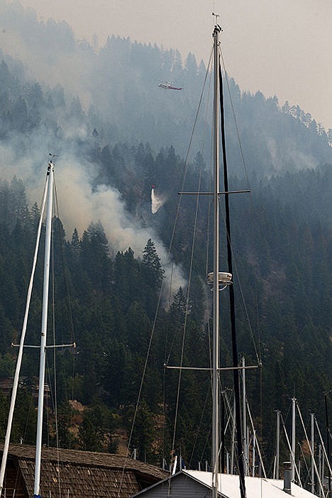 &lt;p&gt;A helicopter drops a bucket of water on the blaze Monday in Bayview.&lt;/p&gt;