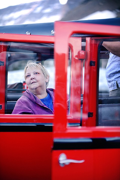 <p><strong>Rhonda Hendricks</strong> takes in the view of the Logan Pass Visitor Center from the red bus. </p><div> </div>