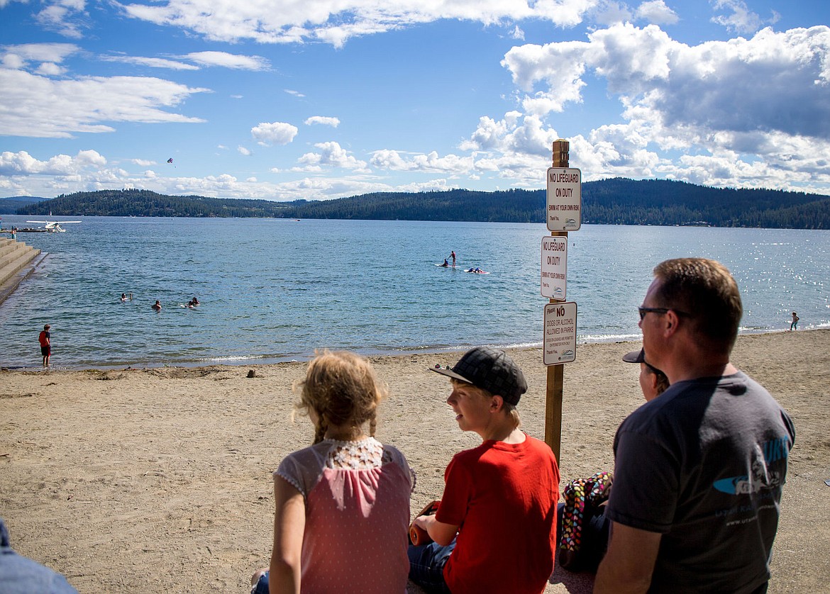 &lt;p&gt;The Young family looks over City Beach and Lake Coeur d&#146;Alene on Wednesday afternoon as people swim without the supervision of lifeguards. The city of Coeur d&#146;Alene will not employ lifeguards to watch over the beach this summer.&lt;/p&gt;