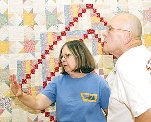 &lt;p&gt;Kris and Pat Hanley admire a quilt known as &quot;Grandmother's Flower Basket&quot; Saturday at Morrison Elementary during Troy's Old Fashion Fourth of July Celebration.&lt;/p&gt;