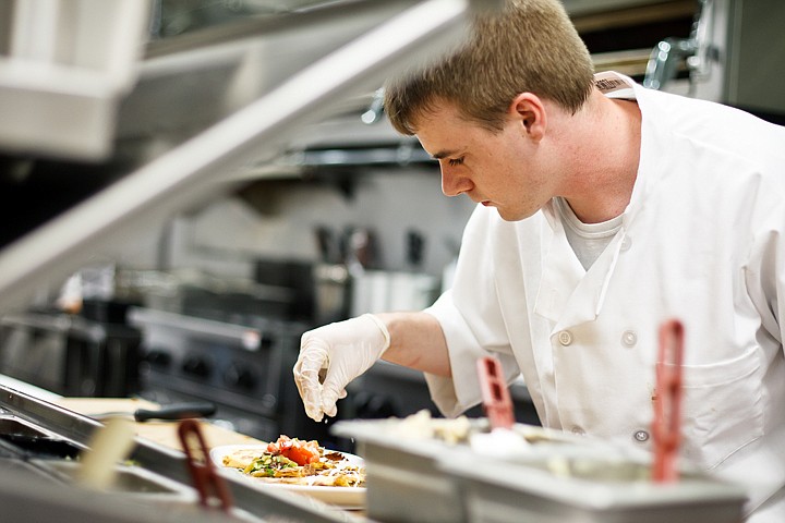 &lt;p&gt;SHAWN GUST/Press Joe Bailey, a line cook at Seasons of Coeur d'Alene Fresh Grill and Bar, sprinkles a garnish onto a lunch order Thursday during his shift.&lt;/p&gt;