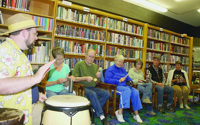 &lt;p&gt;Grant Applehans teaches participants at the Plains Public Library how to play Afro-Caribbean instruments.&lt;/p&gt;