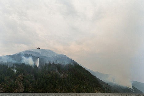 &lt;p&gt;A helicopter drops hundreds of gallons of water on hot spots Tuesday as the Cape Horn fire in Bayview spreads to another point further north.&lt;/p&gt;