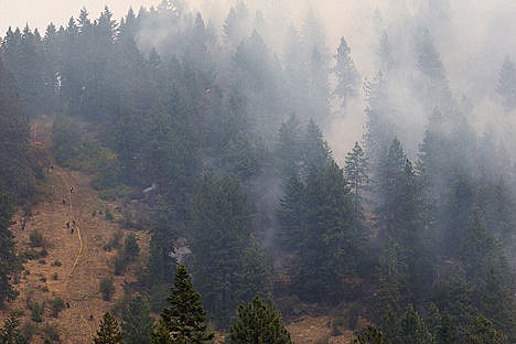 &lt;p&gt;Firefighters work along a fire line to the west of the blaze as efforts to contain the fire continue.&lt;/p&gt;