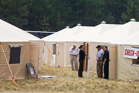 &lt;p&gt;Emergency personnel meet near a series of logistical tents at a fire base camp in Farragut State Park.&lt;/p&gt;