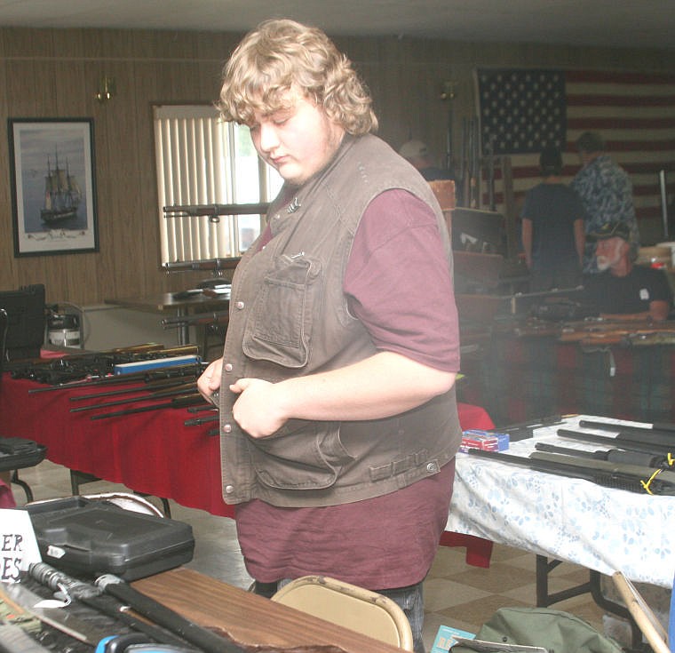 &lt;p&gt;Matt Boudreau looks over his inventory at a gun show in Plains on Saturday, June 29. Bourdreau said this was the first gun show he had ever participated in as a vendor.&lt;/p&gt;