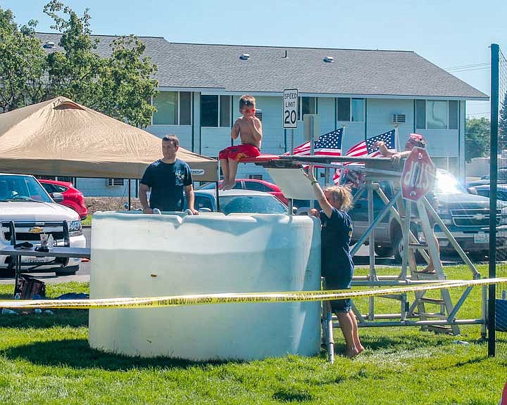 Chamber volunteers run the dunk tank at Lions Park during Othello's July 4 celebration.