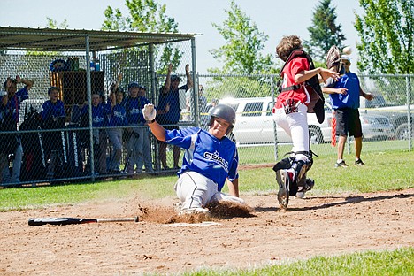 &lt;p&gt;Kyle Torres of Coeur d'Alene slides home with the final run of Saturday's game between Coeur d'Alene and Sandpoint in the Idaho District 1 Little League Majors (age 11-12) tournament at the Canfield Sports Complex in Coeur d'Alene.&lt;/p&gt;