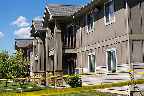 &lt;p&gt;Police tape lines the grounds near a Tullamore Commons apartment complex unit, the scene of a Post Falls homicide investigation.&lt;/p&gt;