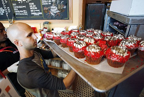 &lt;p&gt;Crumbs Bake Shop managing partner Harley Bauer carries of tray of cupcakes during the store's grand opening on Sept. 20, 2007, in Beverly Hills, Calif. Crumbs said it is shuttering all its stores, a week after the struggling cupcake shop operator was delisted from the Nasdaq.&lt;/p&gt;