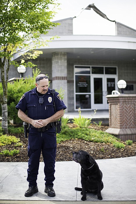 &lt;p&gt;Patrol officer Craig Buhl, with the Coeur d'Alene Police Department, and Justice, a 12-year-old drug-sniffing dog, share glances Monday in front of the police department. The K-9 recently retired form active duty.&lt;/p&gt;