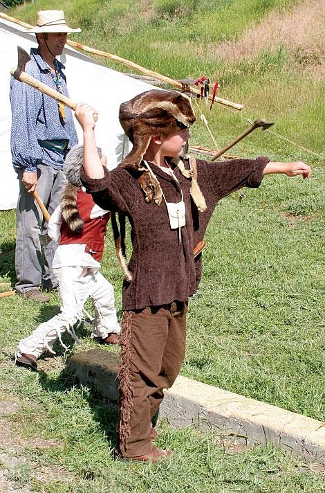 Jamie Doran/Valley Press Lucas Fuhrman, age 7, from Thompson Falls, throws a tomahawk at the Thompson Days historical re-enactment.