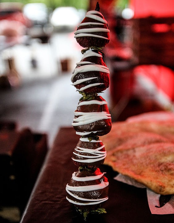 <p>KATIE HARTWIG/Press Chocolate covered strawberries on a stick at Q'emiln Park, during the craft show on Saturday afternoon.</p>