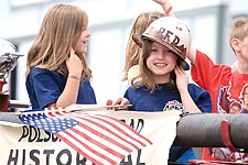 Shea McGuinness represents the Polson Fire Department atop the fire engine during Sunday's parade.