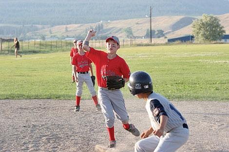 Jamie Doran/Valley Press Zach Osborne scrambles to throw the ball to first base Wednesday night.