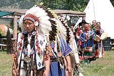 Maii Pete leads the escort song before the Scalp Dance during Thursday's Old Style Days at the Arlee Powwow. Calling all women to the chief's camp, announcer Alec Quequesah translated the song's lyrics for the crowd, &quot;lend me your wives, lend me your mother, we're going to have Scalp Dance.&quot;