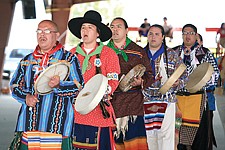 Charlie Quequesah leads the escort song before the Scalp Dance during Thursday's Old Style Days at the Arlee Powwow. Shandin Pete, Tachini Pete, Chaney Bell and Jason Heavyrunner follow him, calling all women to the floor. Announcer Alec Quequesah translated the song's lyrics for the crowd, &quot;lend me your wives, lend me your mother, we're going to have Scalp Dance.&quot;