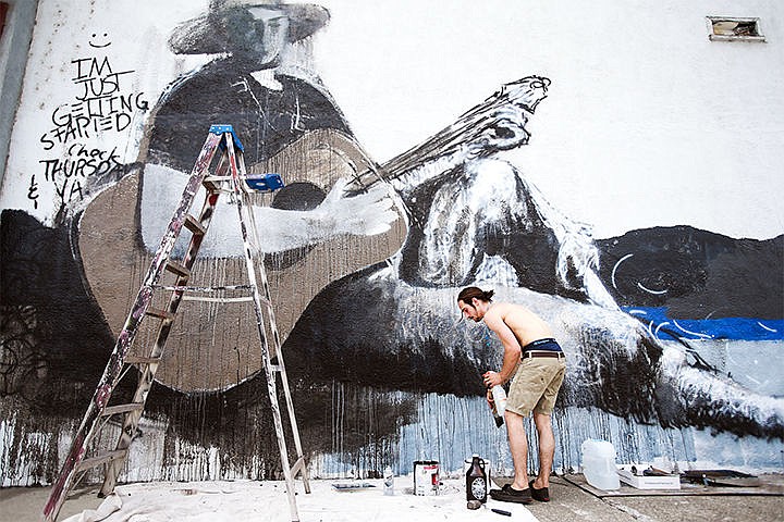 &lt;p&gt;Joshua Martel, 20, gains progress in his mural painting on the side of Burt&#146;s Music and Sound located on East Sherman in Coeur d&#146;Alene. Martel creates this painting of his roommate on a guitar to portray the relaxed environment of Coeur d&#146;Alene, a place he used to call home. Now living in the Portland area, Martel wanted to bring some inspiration and hope to his hometown.&lt;/p&gt;