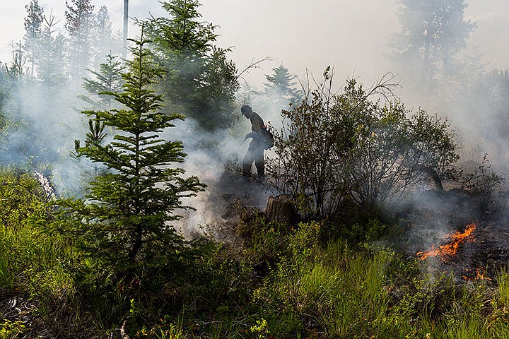 &lt;p&gt;A firefighter works to extinguish several small fires in an effort to contain a larger blaze. The cause of the fire is under investigation.&lt;/p&gt;