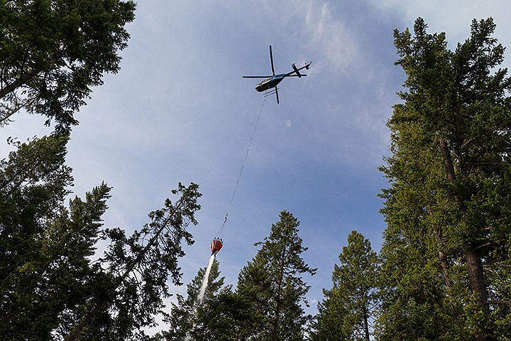 &lt;p&gt;A helicopter empties a 300-gallon bucket of water onto a hot spot after filling up with lake water from nearby Spirit Lake.&lt;/p&gt;